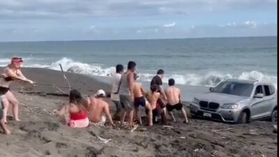 VIDEOS. ¡Casi al agua! Auto de lujo atascado en la playa de Monterrico